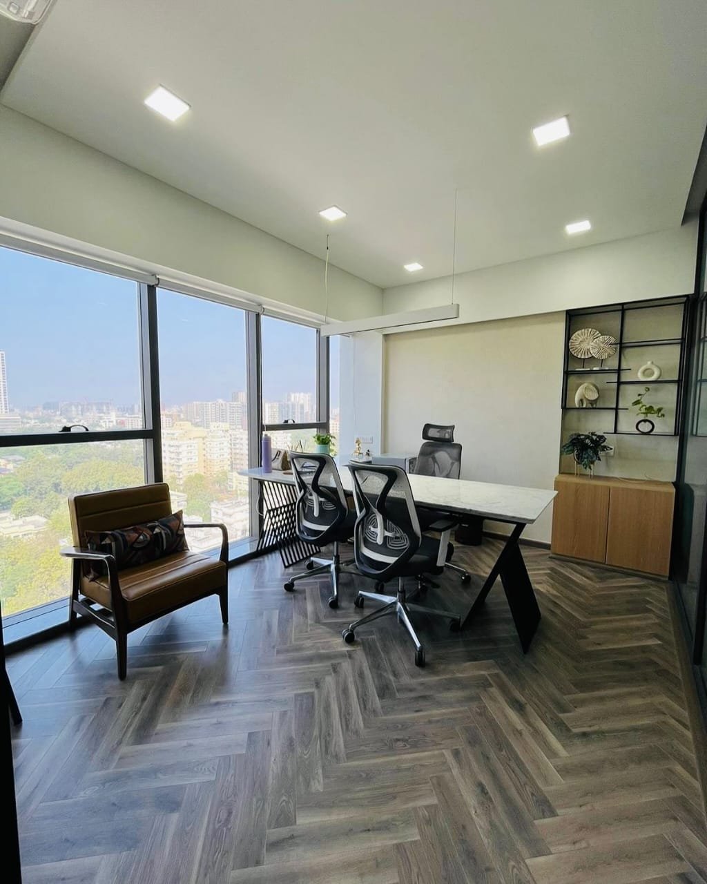 Consultation room at Derma Wellness & Aesthetic Clinic, Ahmedabad — natural light with city view